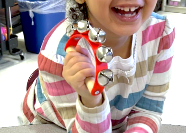A young student playing bells in a Meridian music project